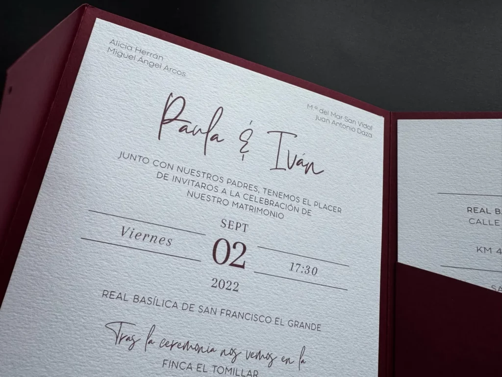 Invitación de boda montada en un sobre carpeta granate